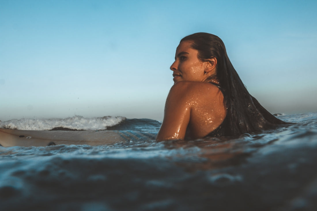topless woman in water during daytime