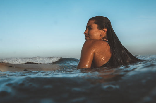 topless woman in water during daytime
