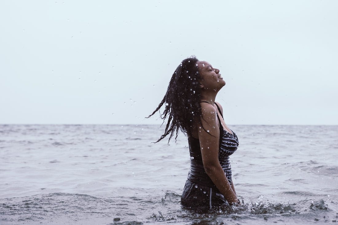 woman in black tank top on water during daytime