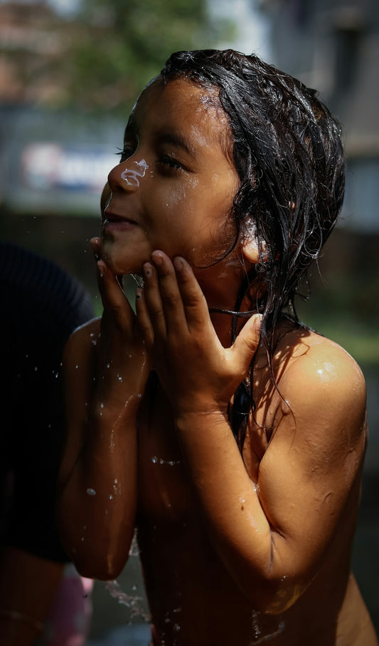a little girl that is standing in the water