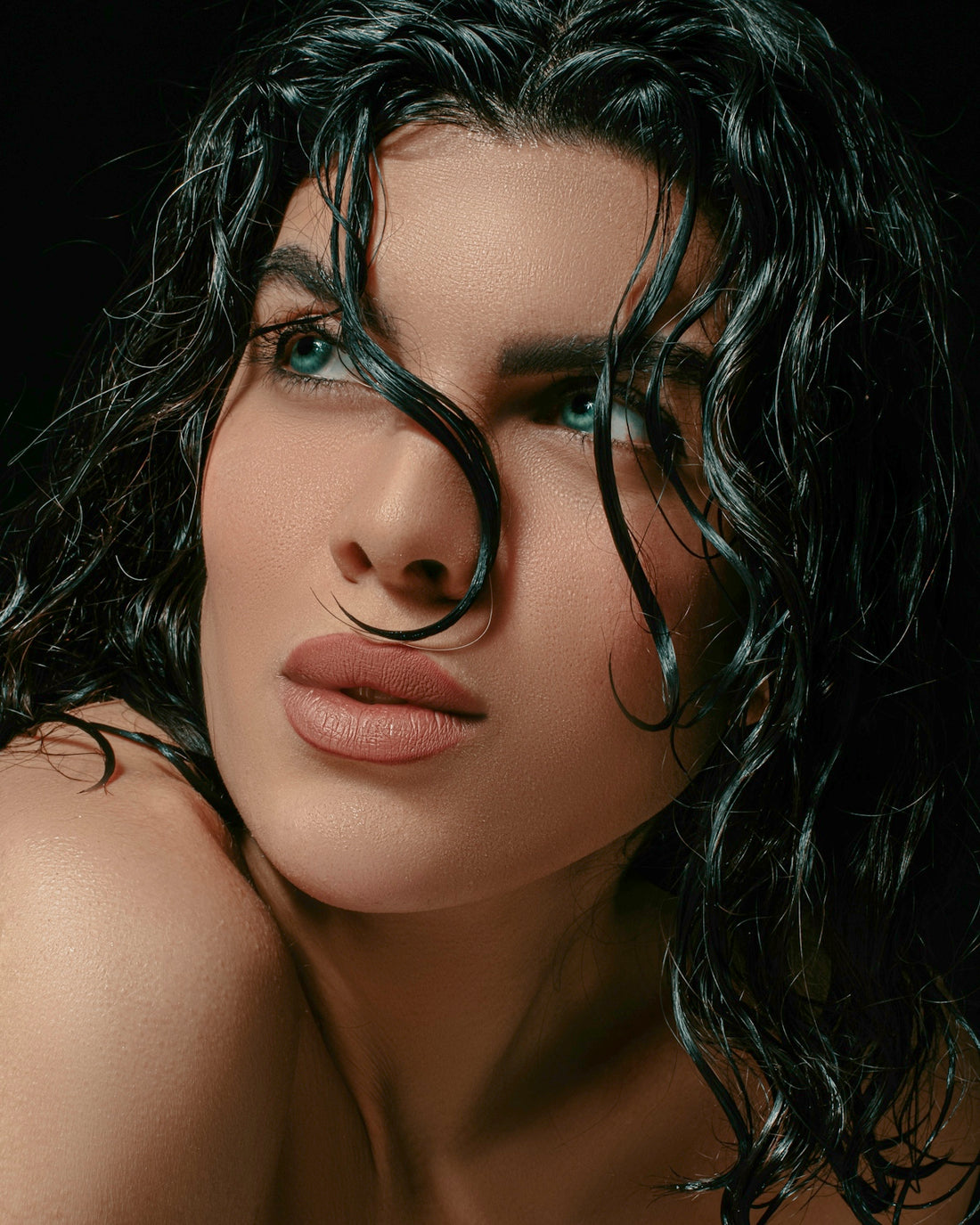 a close up of a woman with wet hair