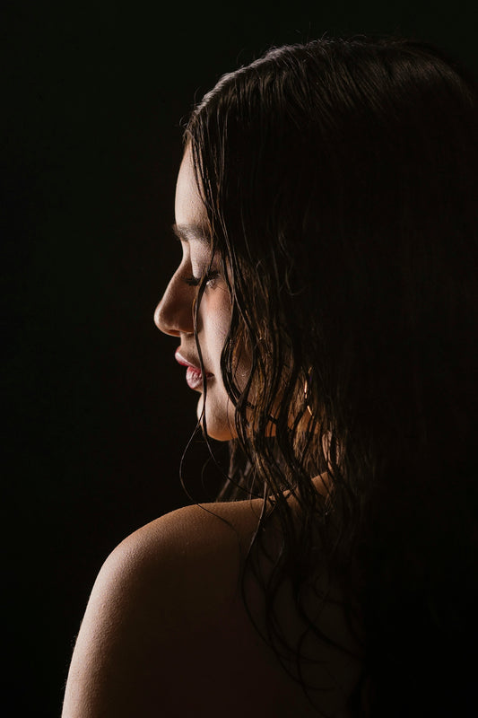 a woman with wet hair is looking down