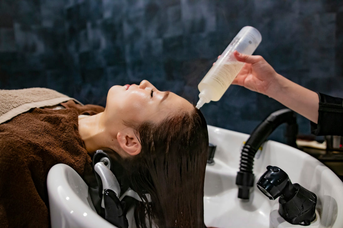 a woman getting her hair washed with a hair dryer