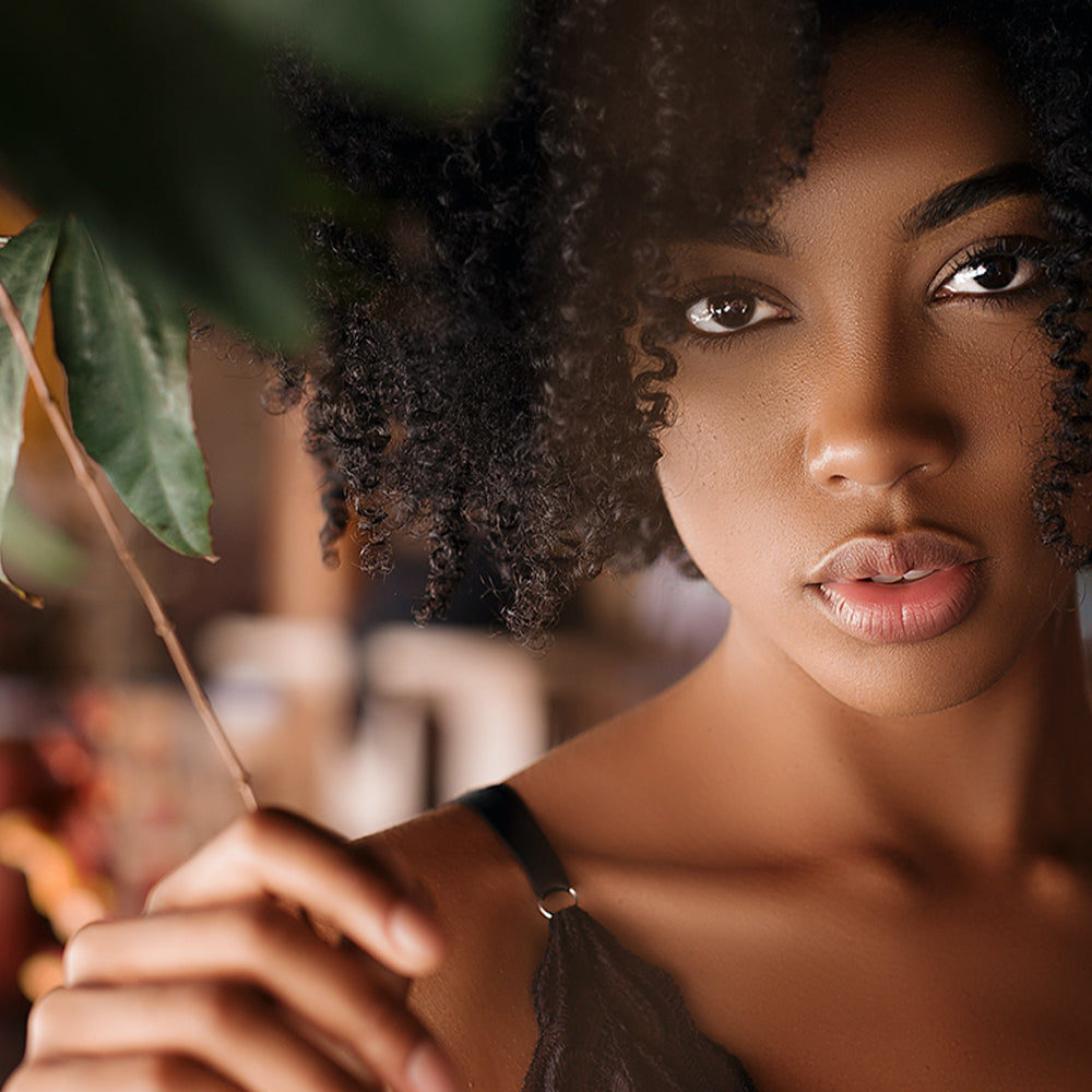 Woman holding a plant with a blurred background